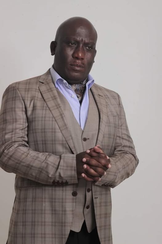 Portrait of Bishop Sello Elly Mogodiri in a plaid suit